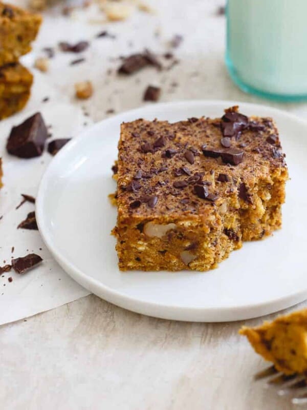 Made with whole wheat flour and oats, these chewy and dense pumpkin chocolate chip bars are an easy and healthier fall treat perfect with a glass of milk!