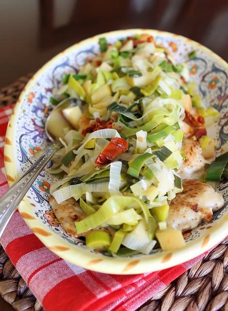 This chicken with leeks is cooked with apples and sun dried tomatoes. A meal fancy enough for guests but easy enough for a weeknight dinner.