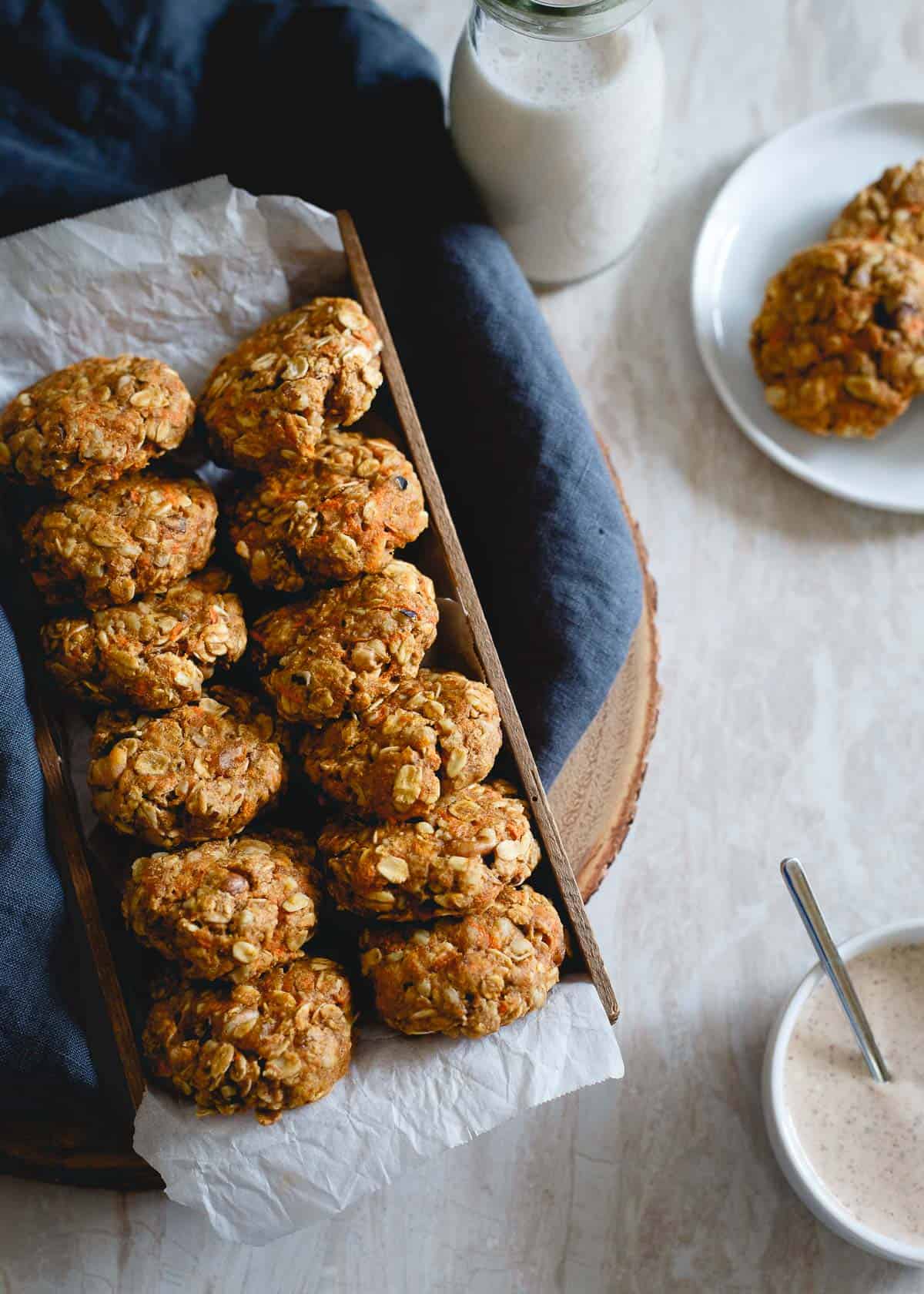 These healthy carrot cake cookies made with oats and whole wheat flour are packed with raisins, walnuts, lemon zest and ginger. Drizzle them with the optional almond butter cream cheese topping for a true creamy carrot cake like bite. No added sugar, no butter, still completely delicious and guilt-free.