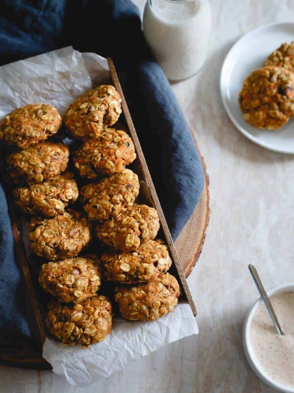 These healthy carrot cake cookies made with oats and whole wheat flour are packed with raisins, walnuts, lemon zest and ginger. Drizzle them with the optional almond butter cream cheese topping for a true creamy carrot cake like bite. No added sugar, no butter, still completely delicious and guilt-free.