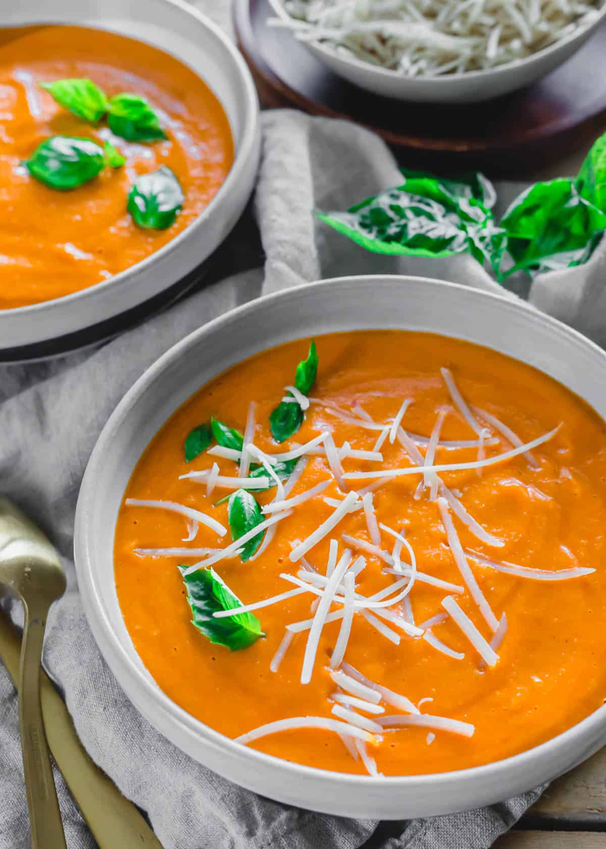 Easy roasted tomato soup with grated parmesan and fresh basil.