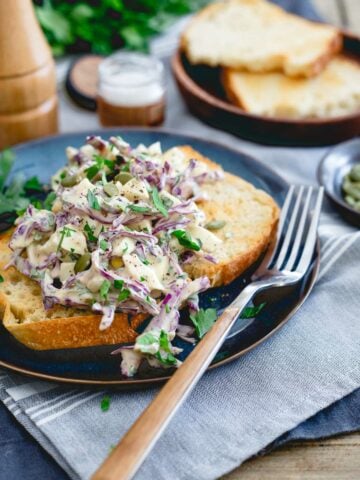 This creamy dijon egg salad is made with Greek yogurt for a healthier twist. Green olives, red cabbage, parsley and pepitas make it flavorful and crunchy!