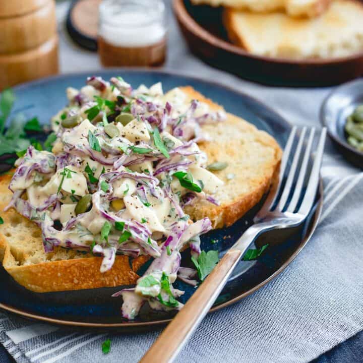 This creamy dijon egg salad is made with Greek yogurt for a healthier twist. Green olives, red cabbage, parsley and pepitas make it flavorful and crunchy!