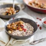 This warm quinoa cereal is topped with a caramelized banana and walnut compote, drizzled in almond butter and garnished with superfoods like goji berries and chia seeds.