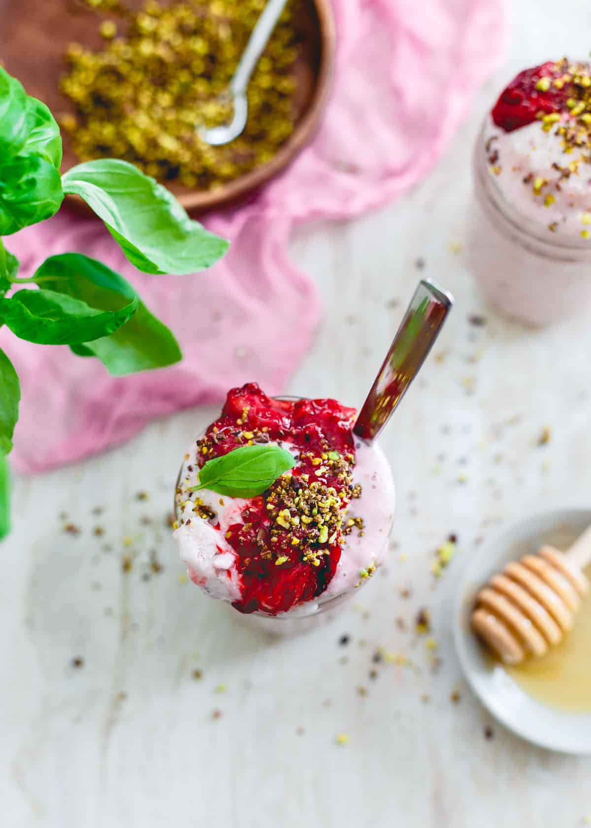 This roasted strawberry basil milkshake is a pretty, pink and festive way to celebrate Valentine's Day! With roasted strawberry topping and a pistachio cacao nib crunch, it's not your average milkshake!