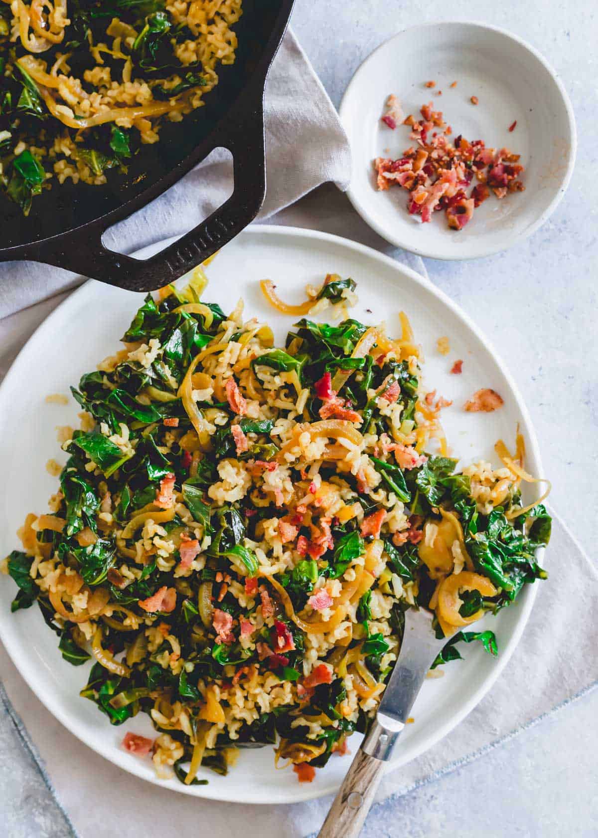 Collard greens side dish with rice, onions, bacon and spices.