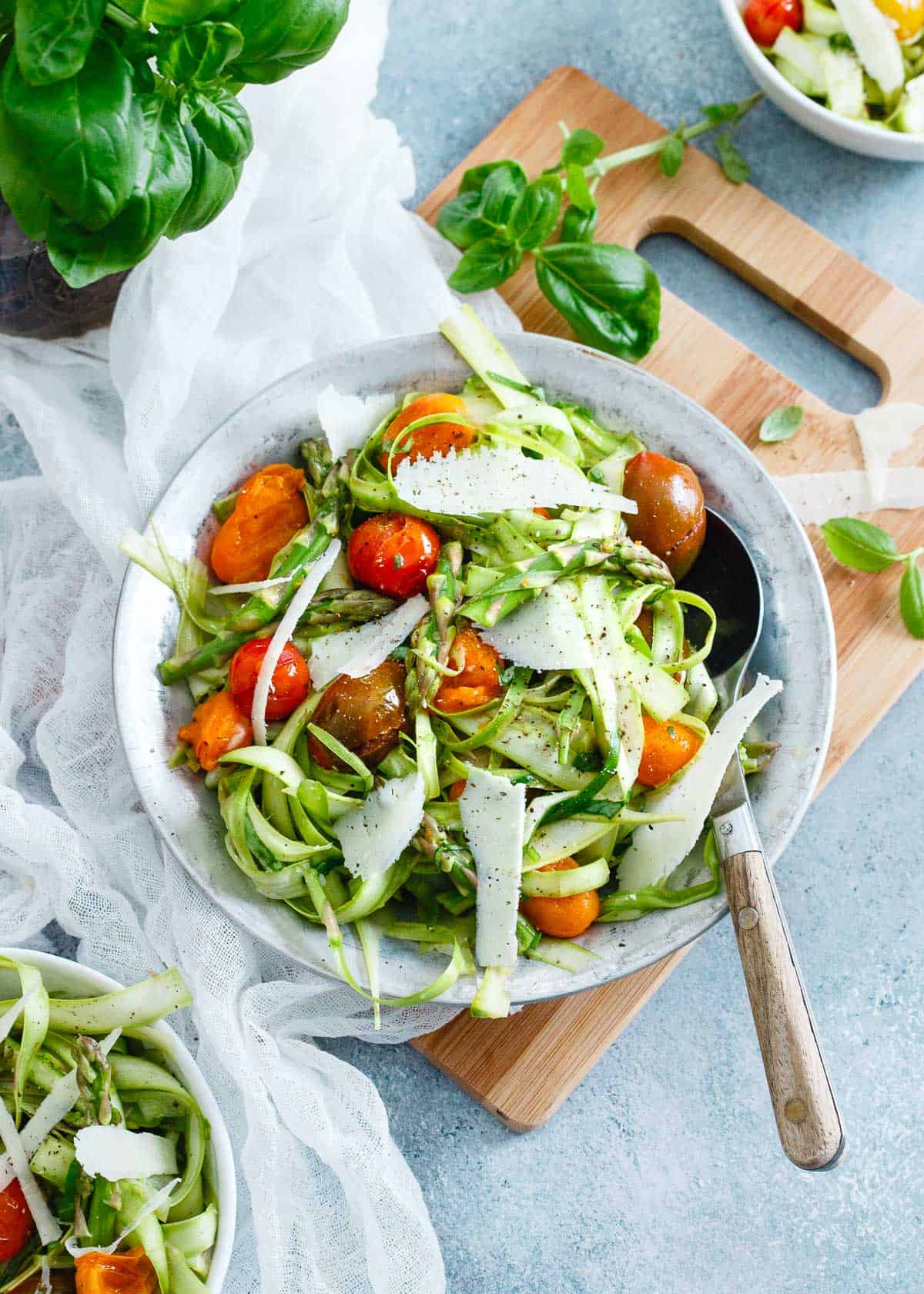 This asparagus tomato salad is bursting with bright lemon flavor. Topped with sharp parmesan and fresh basil it's the perfect way to ring in the spring season.