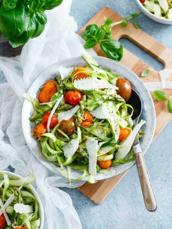 This asparagus tomato salad is bursting with bright lemon flavor. Topped with sharp parmesan and fresh basil it's the perfect way to ring in the spring season.