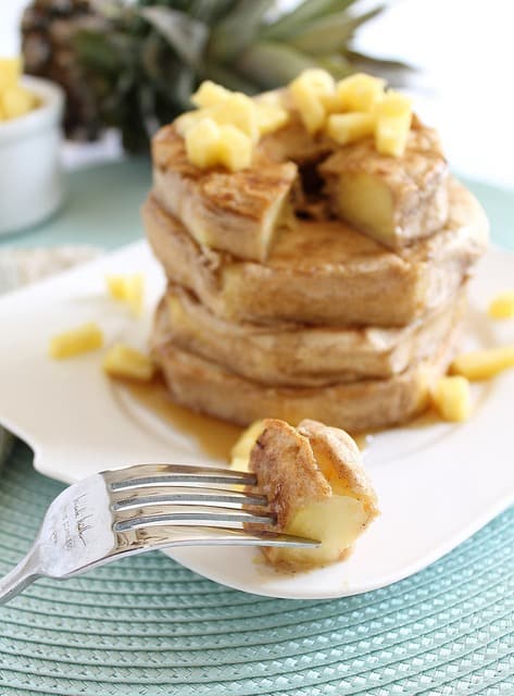 Sweet juicy fresh pineapple rings are coated in a simple pancake batter for a delicious tasting non-traditional pancake stack.