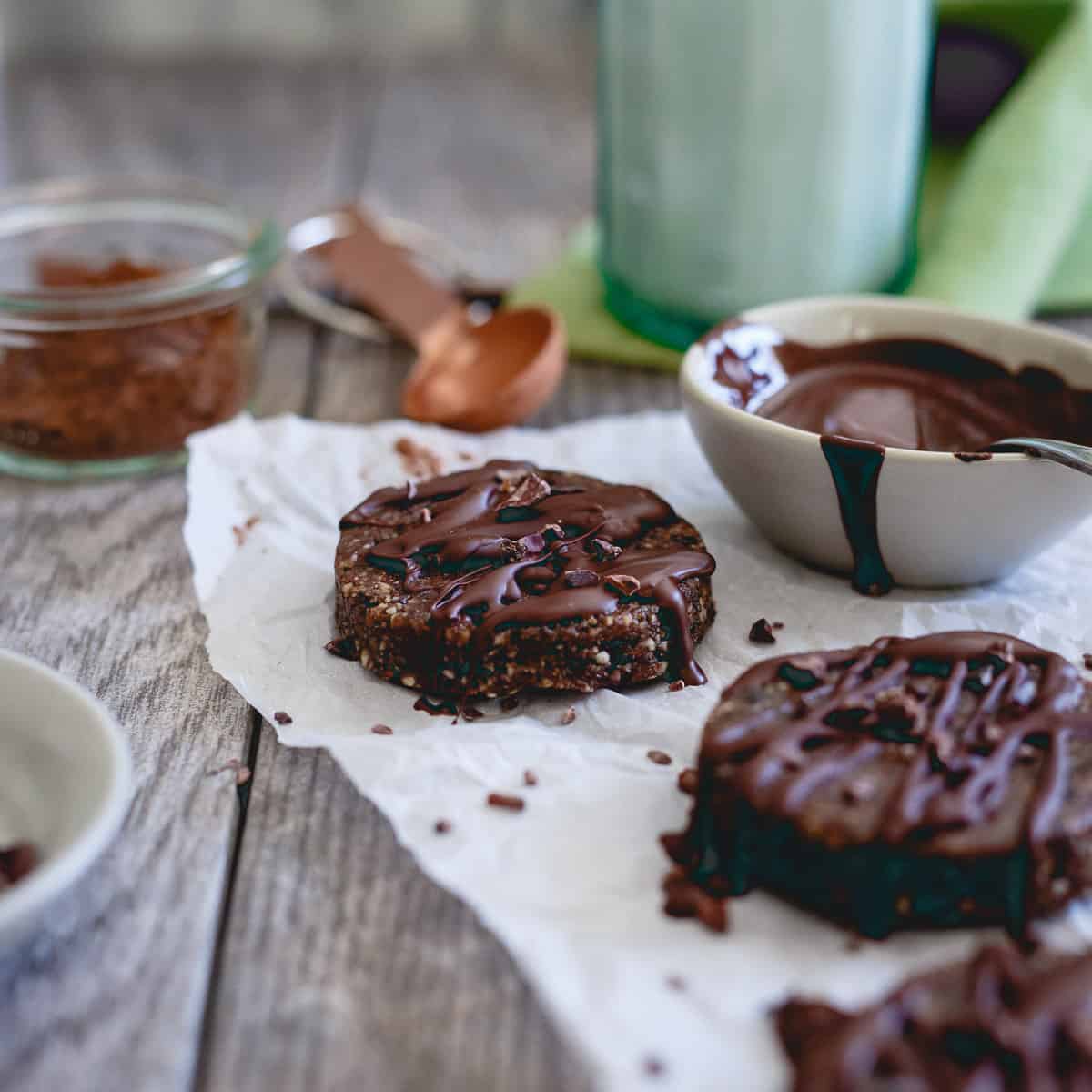 Raw brownie bites are a healthy way to satisfy a chocolate craving. Made with nuts, dried fruit and a chocolate drizzle, they're paleo, gluten-free and vegan dessert you can feel good about eating.