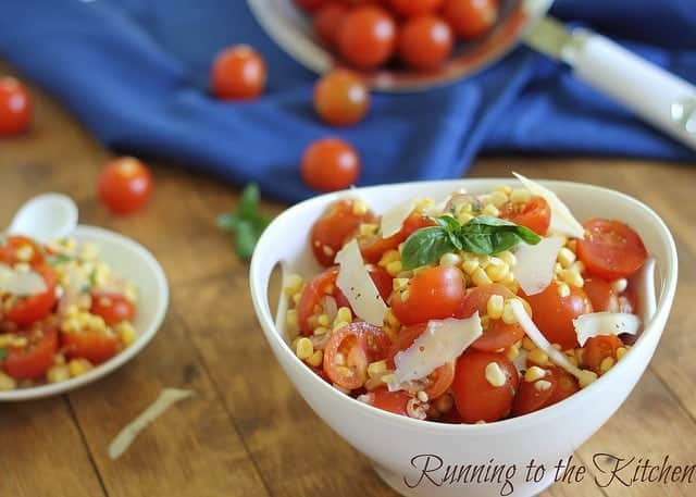 Simple summer corn and tomato salad in a white bowl with shaved parmesan. Simple summer corn and tomato salad in a white bowl with shaved parmesan.