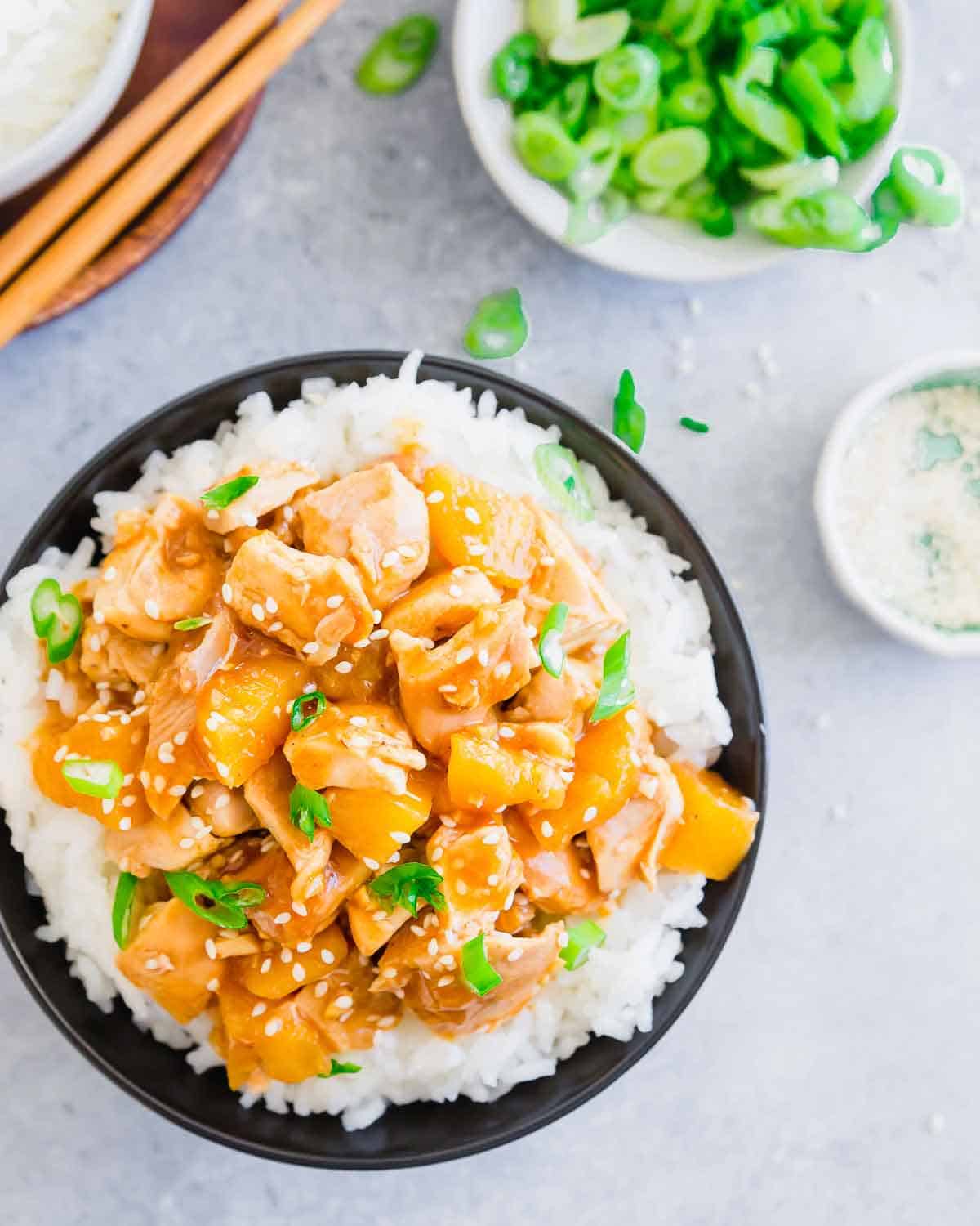 A sweet and stick honey garlic ginger sauce coats chicken thighs and pineapple chunks in this easy slow cooker dinner recipe.