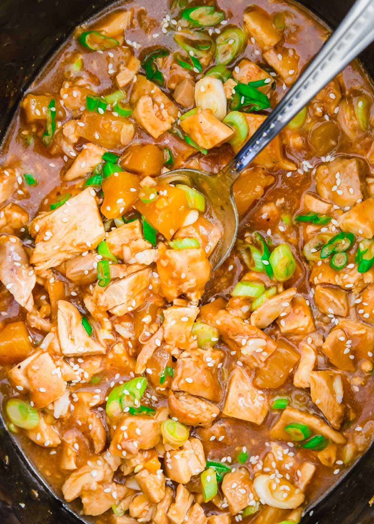 Honey garlic chicken thighs cooked in the slow cooker are a delicious takeout fakeout dinner recipe.