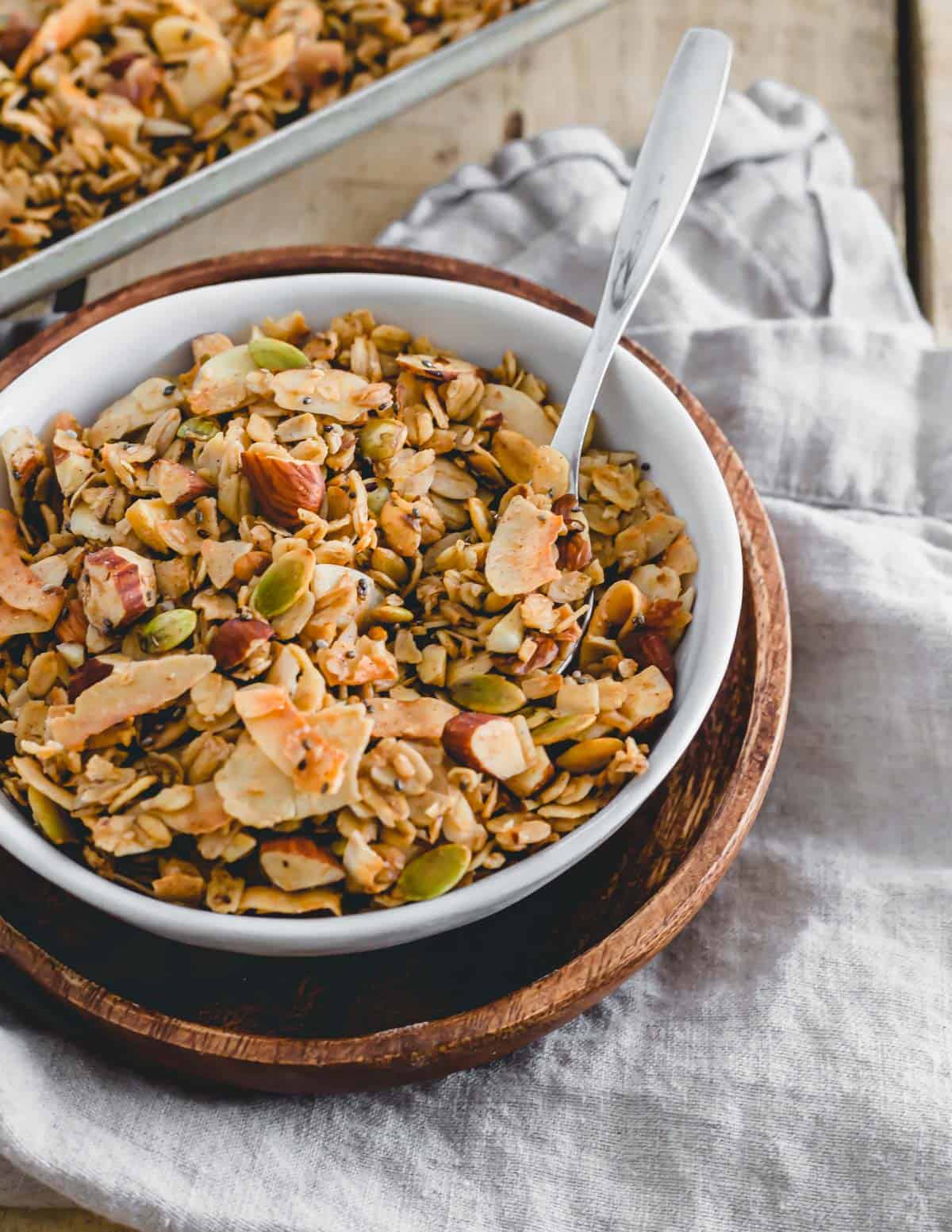 Gluten-free coconut almond granola in a bowl with a spoon.