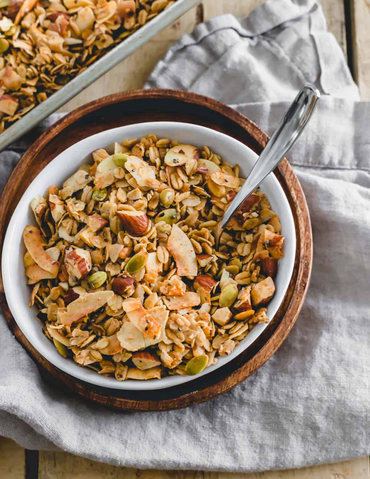 Coconut almond granola in a small white bowl.