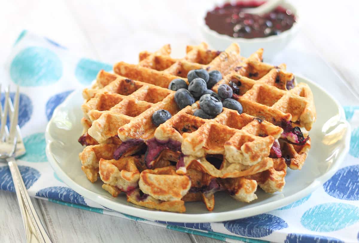 Oatmeal waffles topped with blueberries.