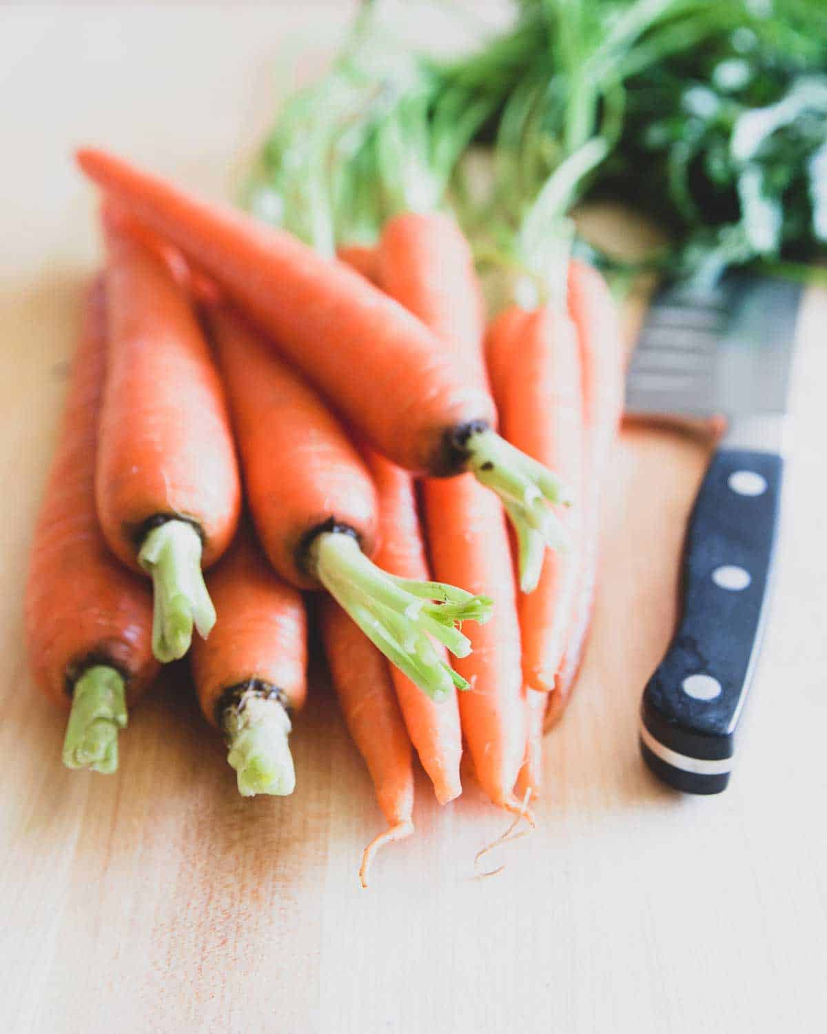 Tender spring carrots with greens become candied with brown sugar and butter on the stovetop.