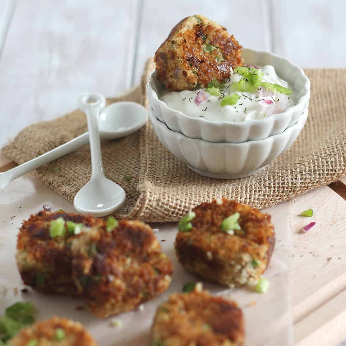 Dipping a salmon bite in yogurt sauce.