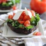 Arugula tomato and ricotta salata stuffed portobello mushrooms.