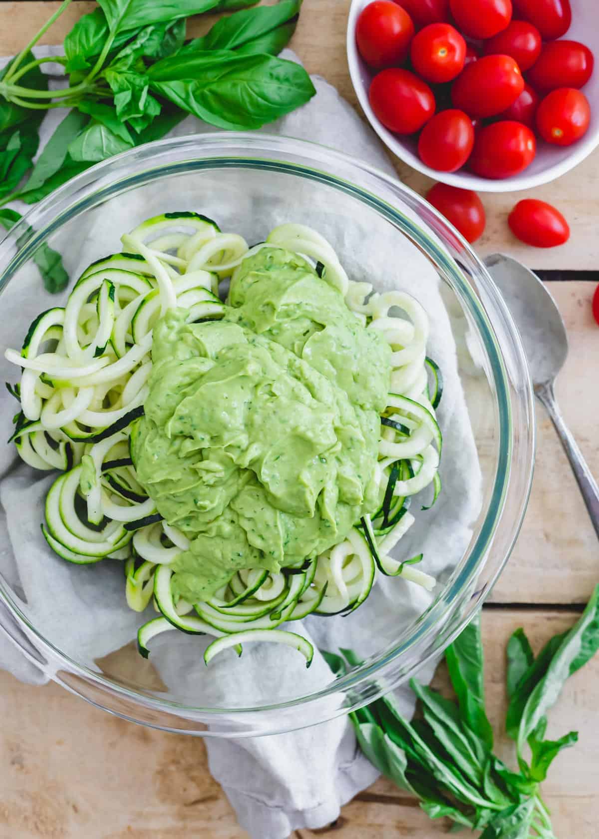 Zucchini noodles in a bowl with a creamy avocado sauce.