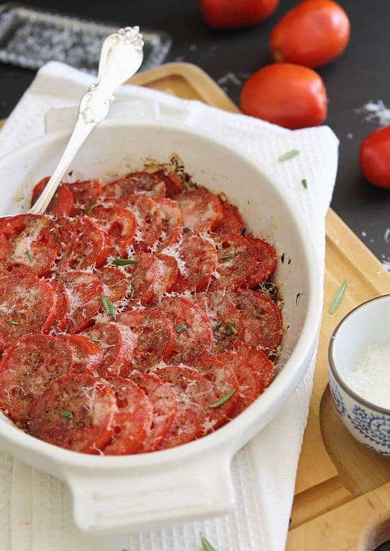 Tomato gratin in a baking dish topped with parmesan cheese.