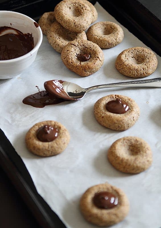 Thumbprint cookies with chocolate spooned in the middle.