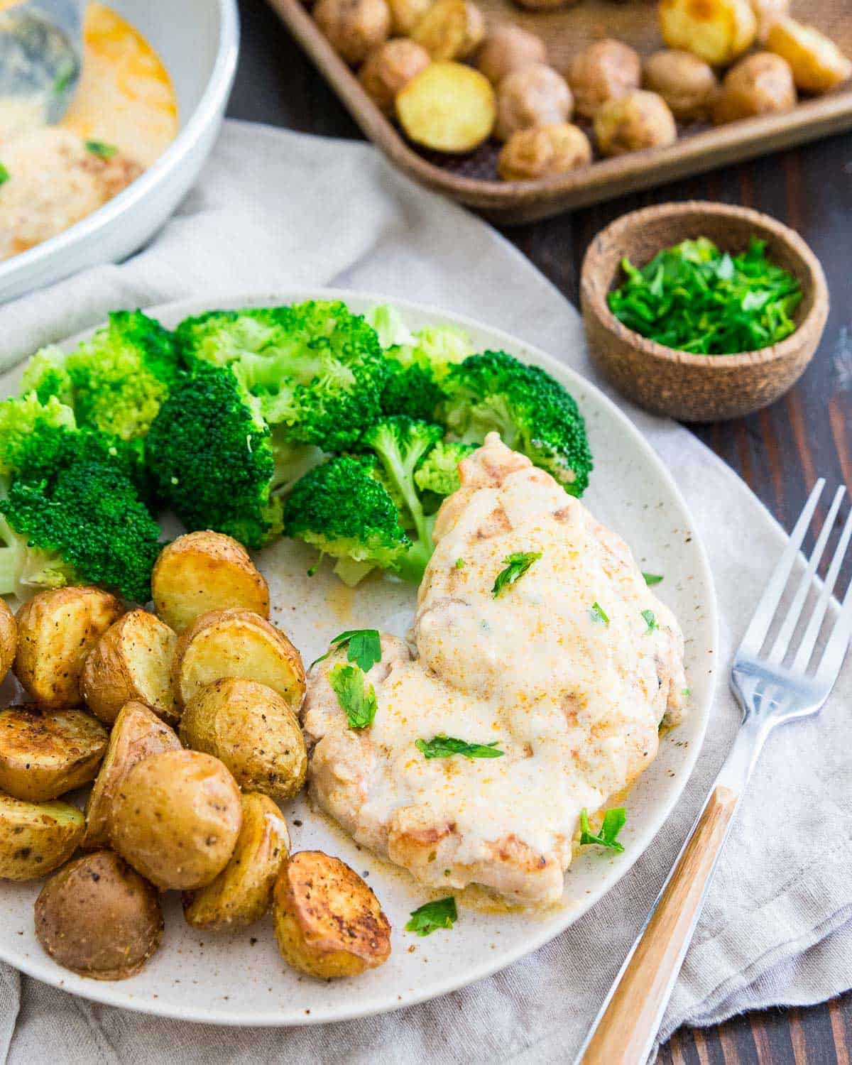 This chicken cream cheese recipe is an easy dinner served with roasted potatoes and steamed broccoli.