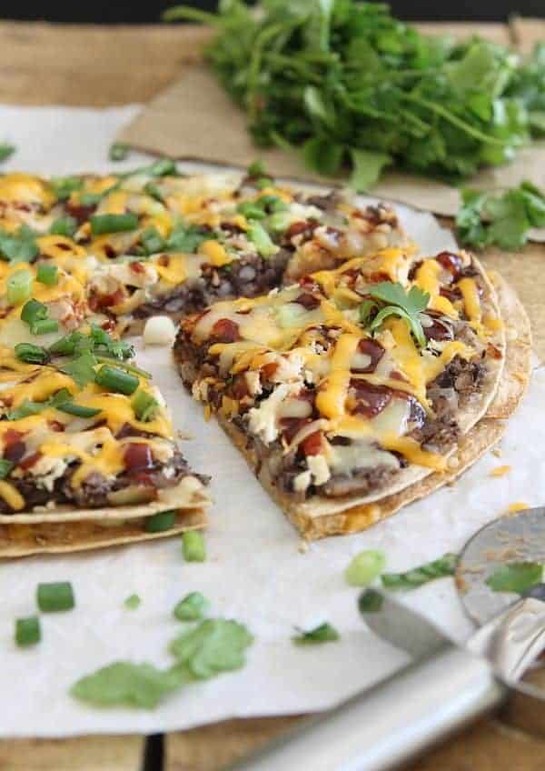 This BBQ black bean tortilla pizza makes a great game day appetizer or a tasty cheesy dinner.