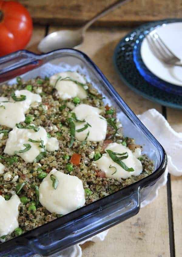 This beef pesto quinoa bake is filled with ground beef, tomatoes, peas and ricotta for an easy throw together dinner.