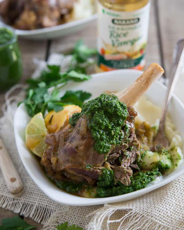 These citrus braised lamb shanks are served with a spicy green harissa. They're cooked until falling off the bone tender.