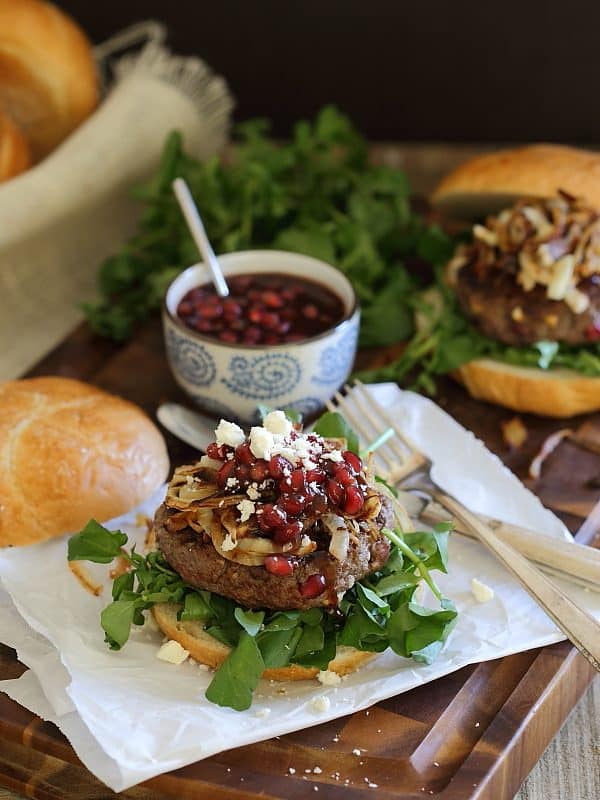 These bison burgers are filled with pomegranates and feta cheese and topped with caramelized onions and a quick pomegranate sauce. They make the perfect winter burger.