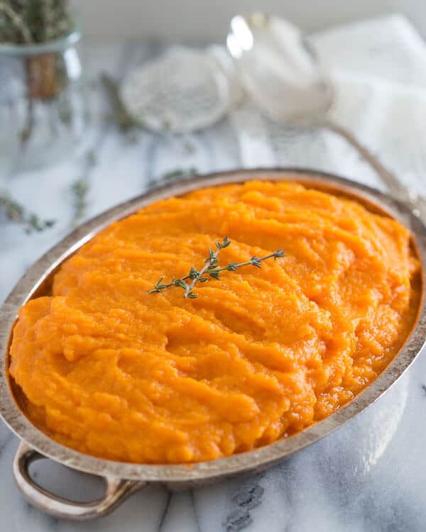 Carrot parsnip puree in a small dish.