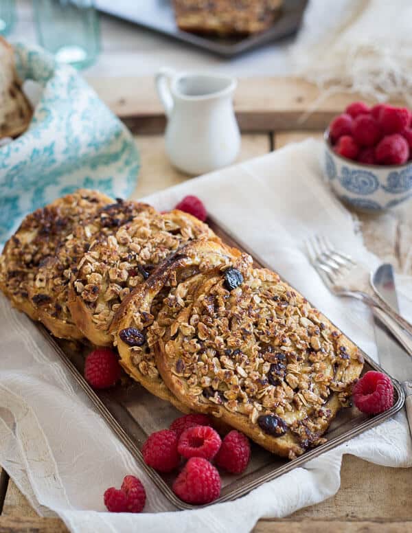 This granola French toast is made with KIND raspberry clusters with chia seeds and topped with a simple raspberry mash. It's a healthy way to jazz up French toast!