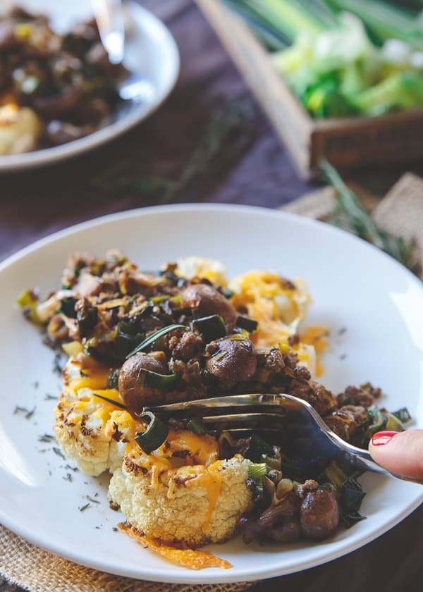 Bison and Cheddar Topped Cauliflower Steaks make a hearty and comforting winter meal packed with flavor.