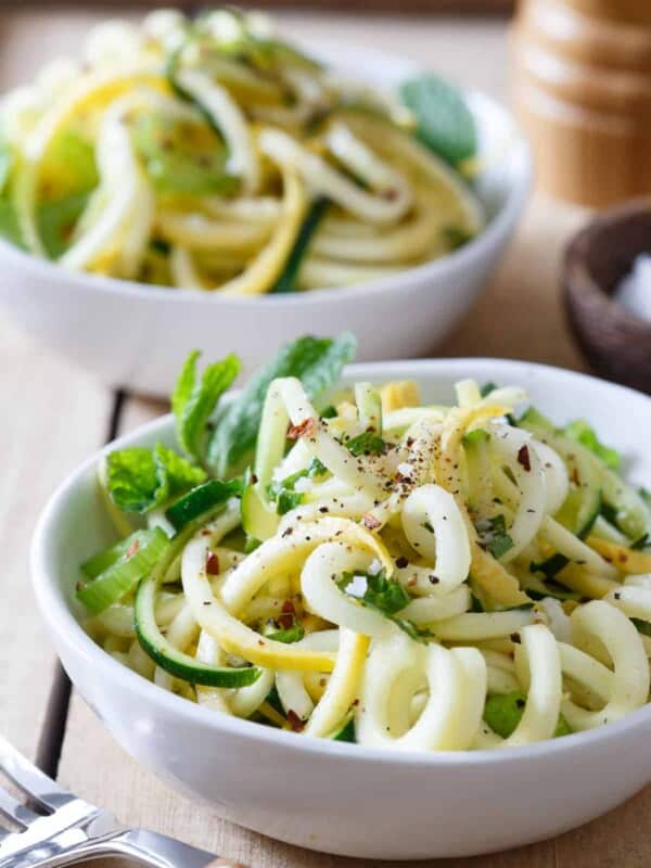 Basil and mint squash noodles in a white bowl.