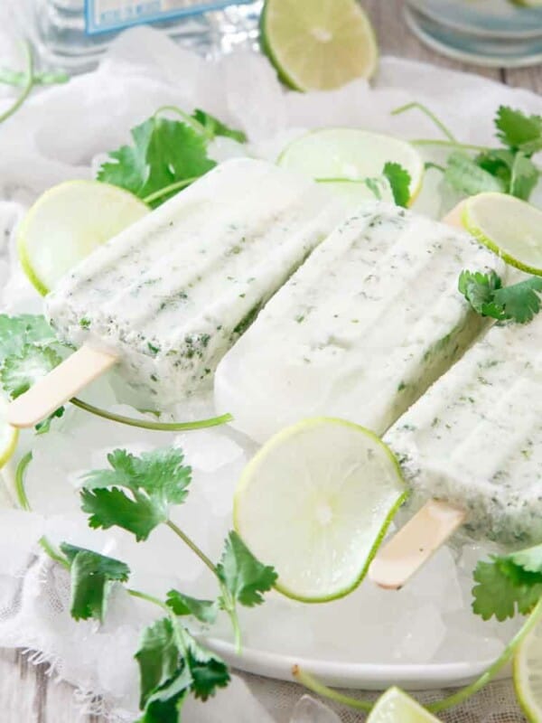 These coconut cilantro margarita ice pops are a refreshing and boozy bite. What better way to do happy hour than with a margarita ice pop?