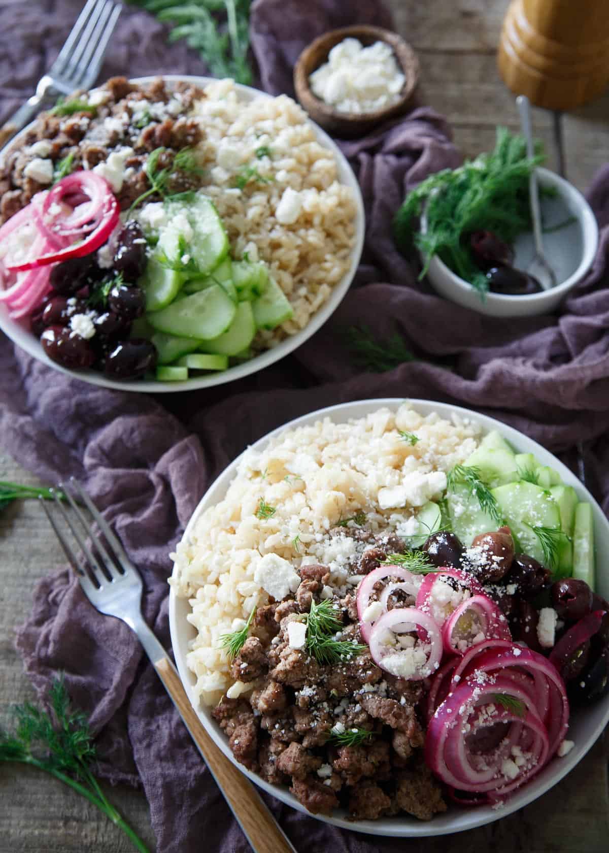 These Greek brown rice bowls are filled with everything you love about a gyro and a Greek salad combined, flavorful lamb, pickled red onions, cucumbers and of course, feta!