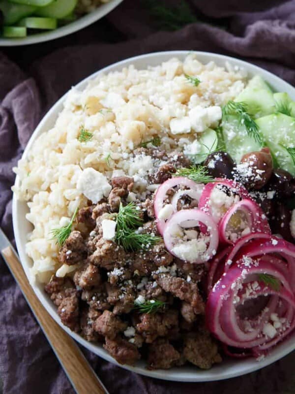 These Greek brown rice bowls are filled with everything you love about a gyro and a Greek salad combined, flavorful lamb, pickled red onions, cucumbers and of course, feta!