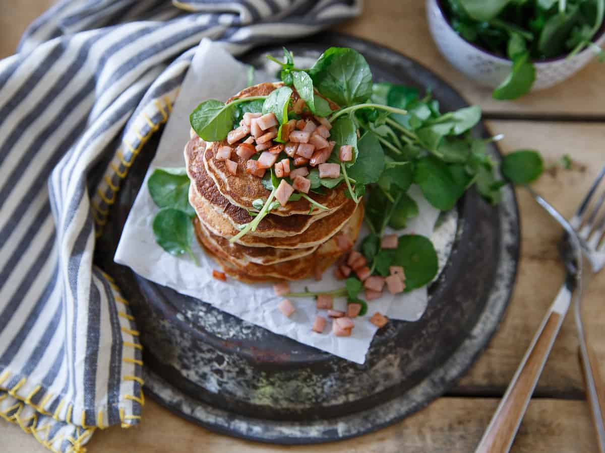 Savory Canadian Bacon Pancakes filled with shallots and herbs, topped with a crispy and refreshing watercress salad.