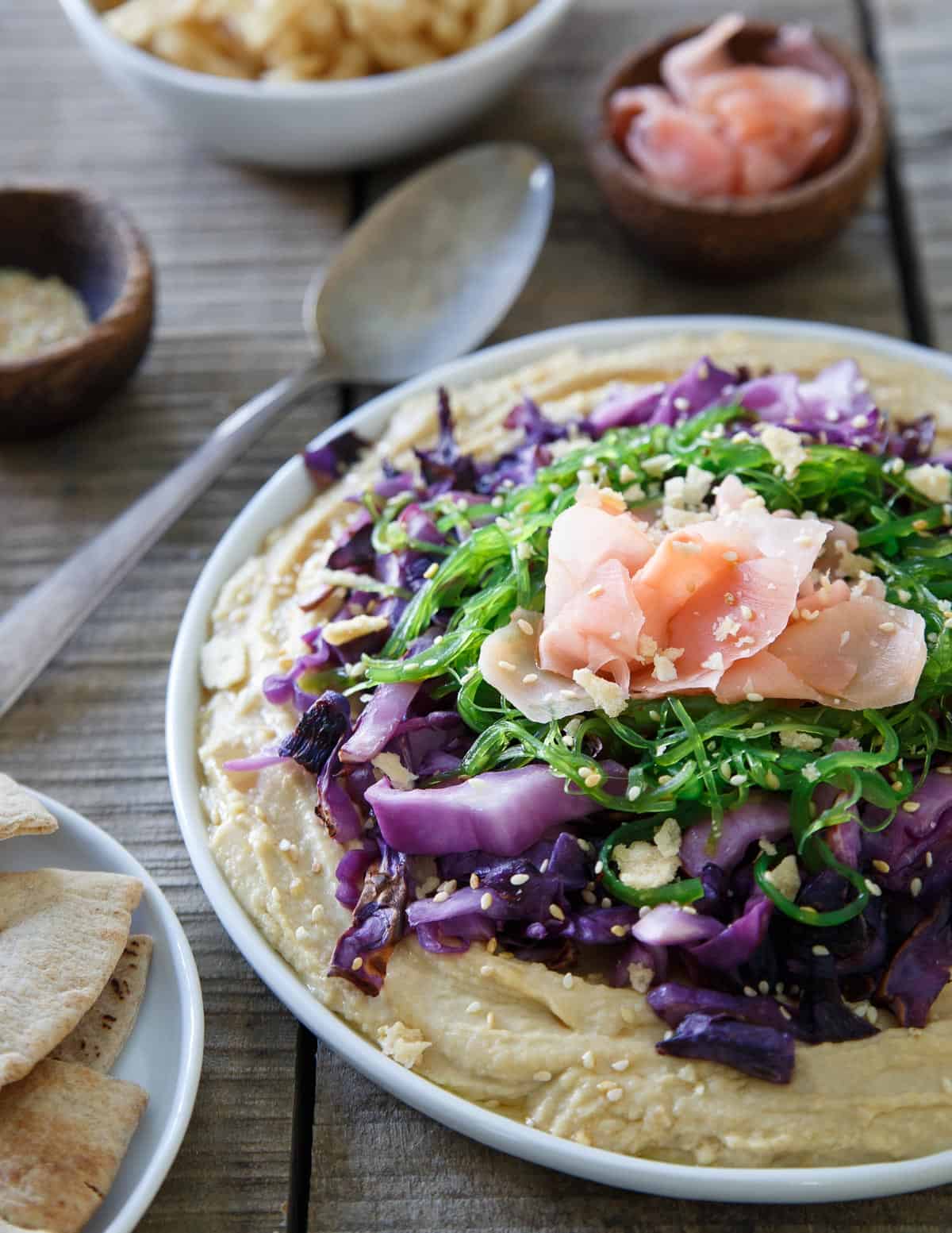 This Asian hummus platter topped with sesame cabbage, seaweed salad and pickled ginger is one tasty way to amp up your appetizer game.