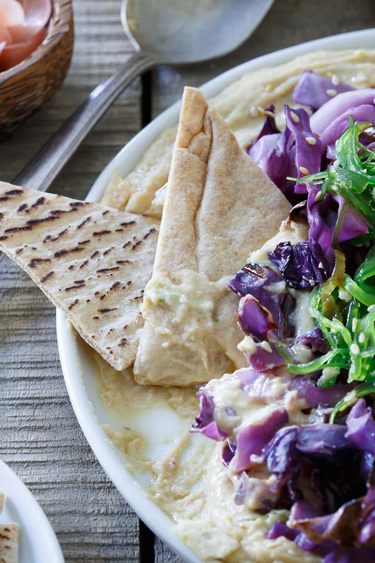 This Asian hummus platter is piled high with sesame sautéed cabbage, seaweed salad and tangy pickled ginger for one delicious dip.