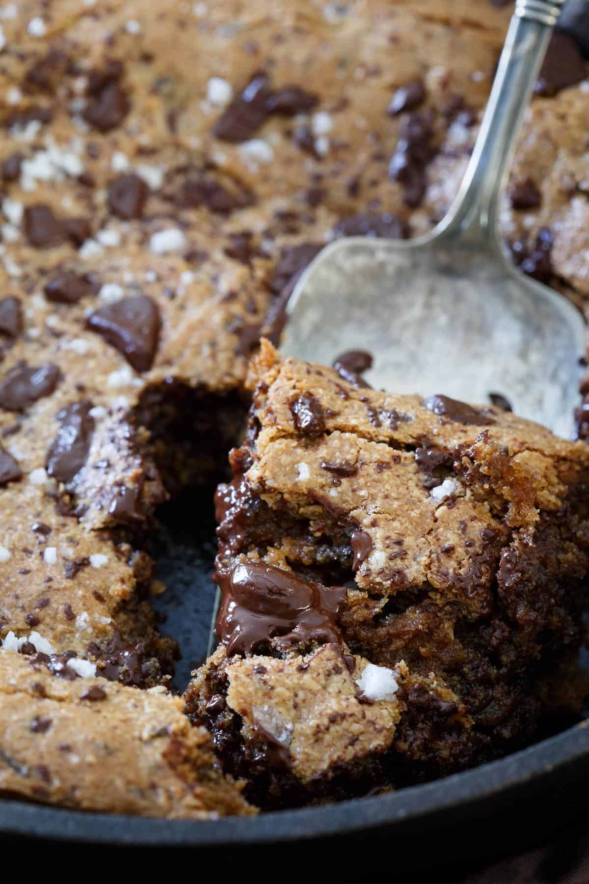 This Paleo salted chocolate chip cookie skillet is decadent, gooey, chocolatey and the perfect grain free dessert.