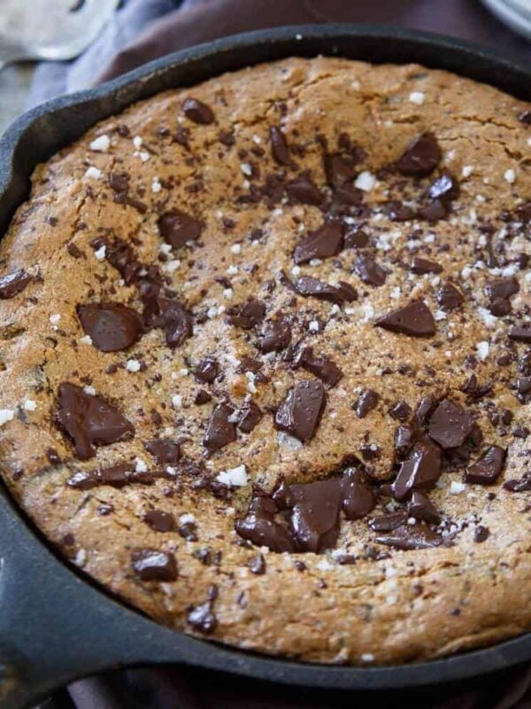 This paleo salted chocolate chip cookie skillet is as simple as 6 ingredients. Just mix and bake off for a decadent, gooey and chocolaty paleo dessert.