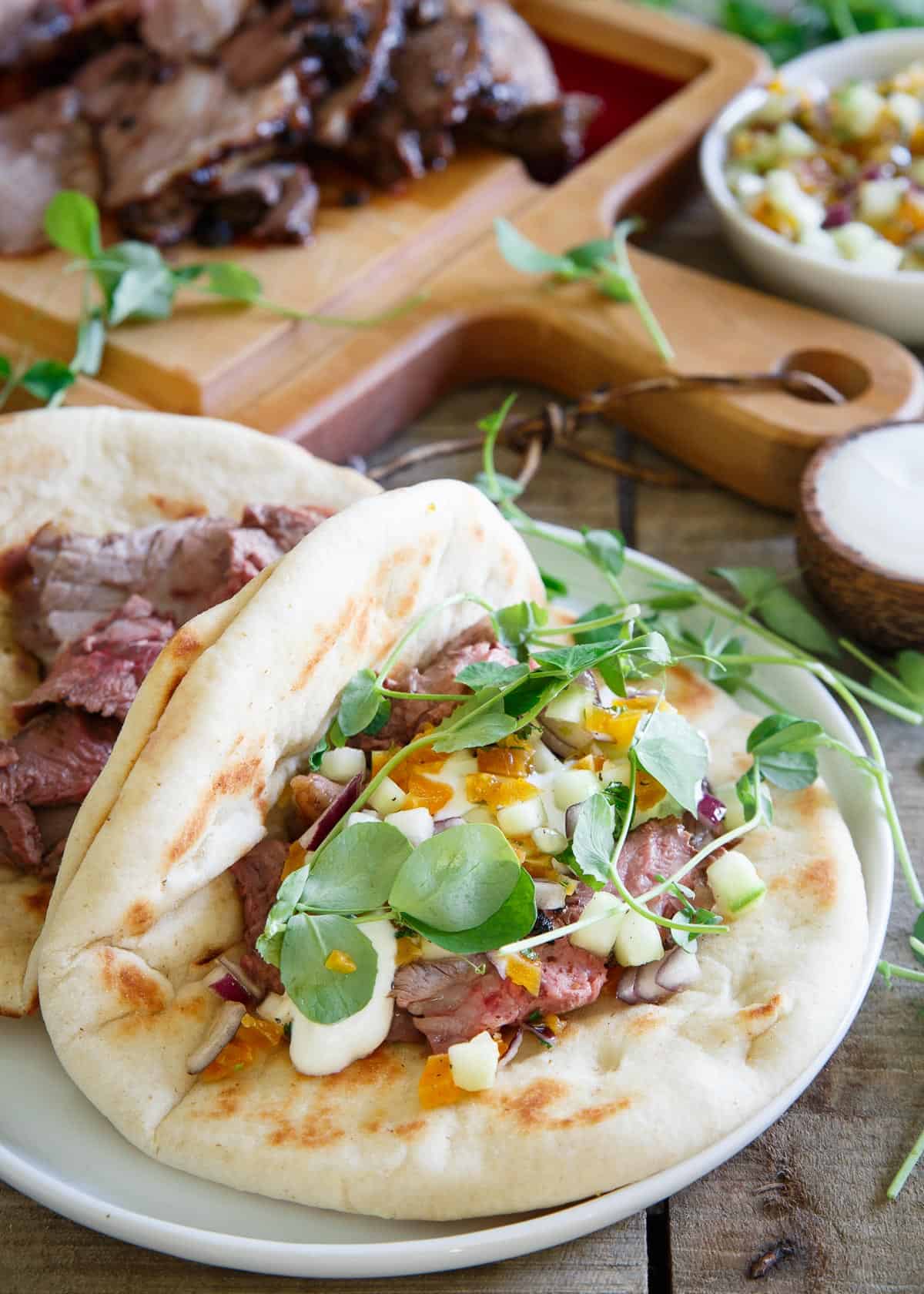 These spring gyros are topped with a sweet and refreshing apricot salsa, quick yogurt sauce and fresh pea sprouts. They're definitely not your average gyro!