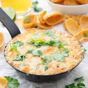 This hummus fundido has a spicy chipotle kick to it. Use chips or even roasted vegetables to dive into this baked cheesy dip.