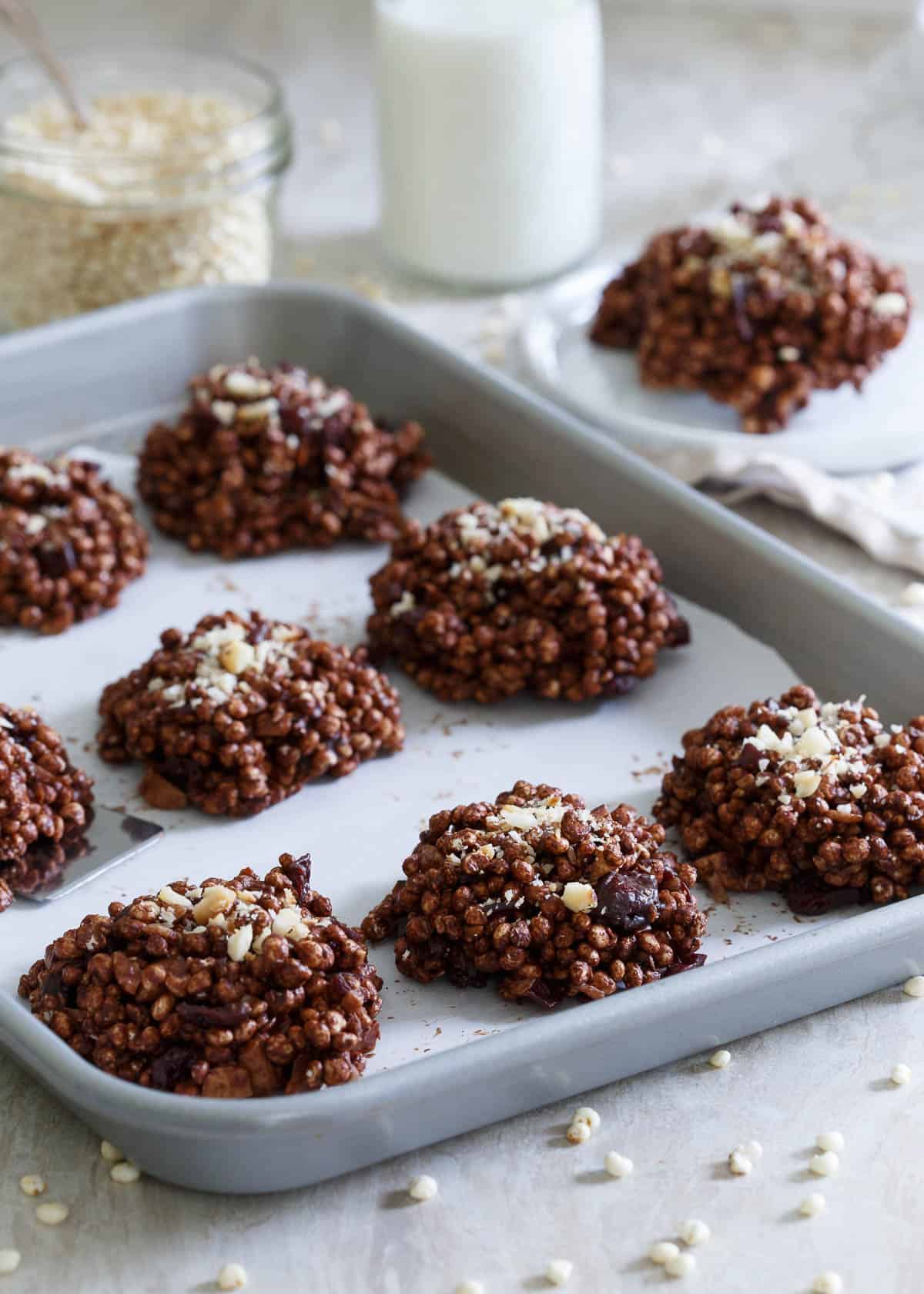 These puffed millet cookies are a no bake treat coated in dark chocolate and filled with dried cranberries and toasted macadamia nuts.