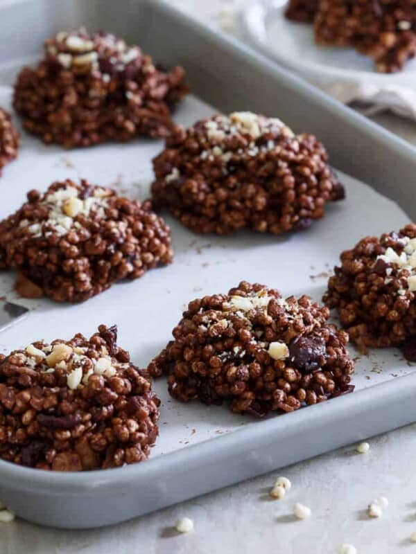 These puffed millet cookies are a no bake treat coated in dark chocolate and filled with dried cranberries and toasted macadamia nuts.