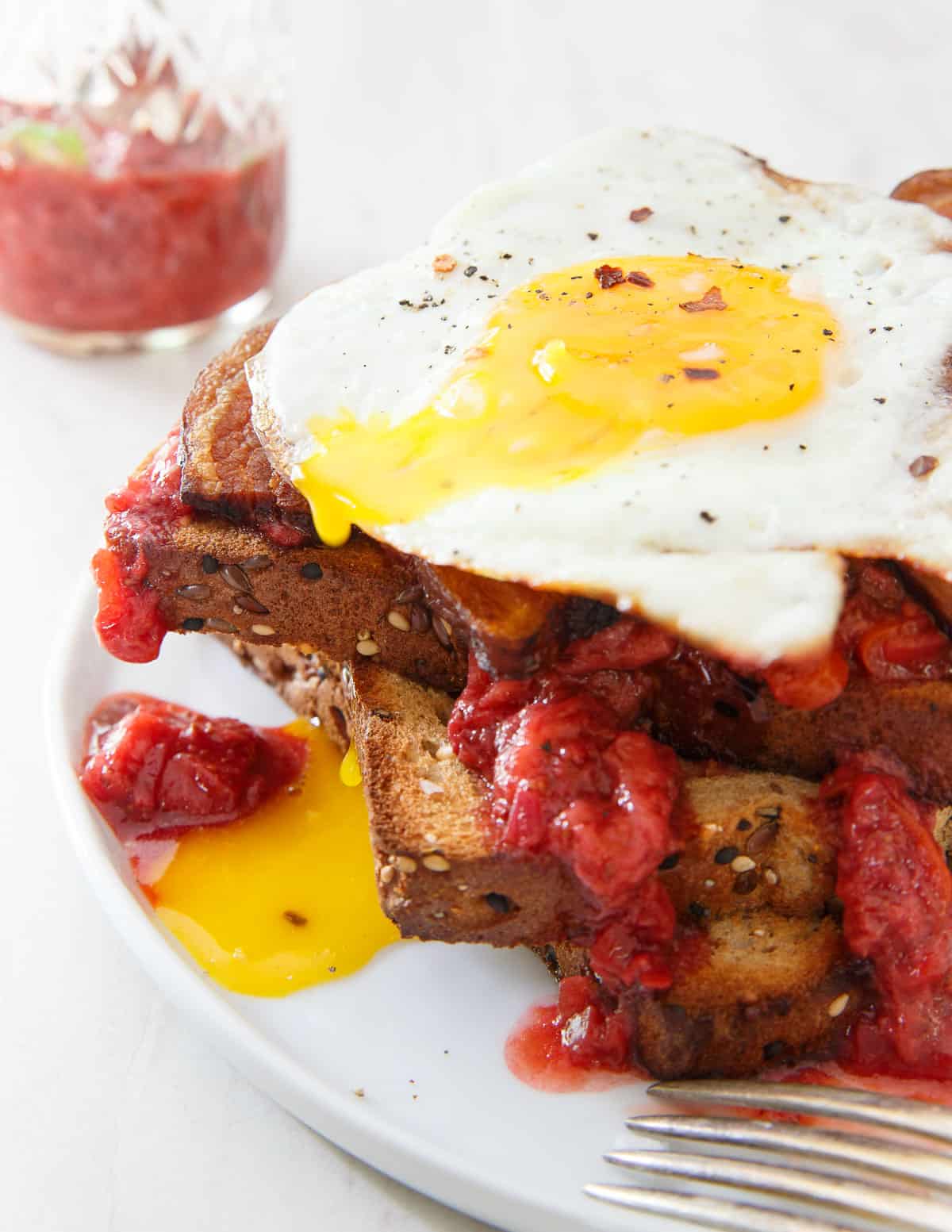 Strawberry Chili Jam makes the ultimate breakfast sandwich with some crispy bacon and a runny egg