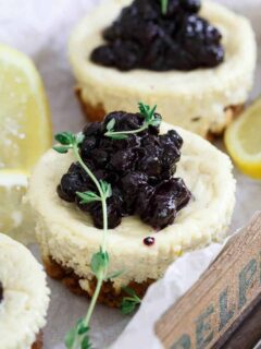 These gluten free granola crust mini cheesecakes are infused with lemon and thyme and topped with a quick blueberry thyme compote.