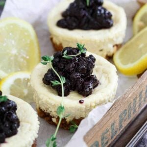These gluten free granola crust mini cheesecakes are infused with lemon and thyme and topped with a quick blueberry thyme compote.